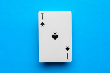 Playing card ace of spades on a blue backgroundの写真素材