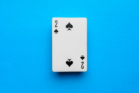 Playing card deuce of spades on a blue backgroundの写真素材