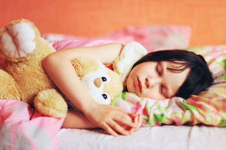 The little girl sleeping on the bed.の写真素材