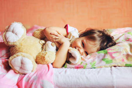 The little girl sleeping on the bed.の写真素材