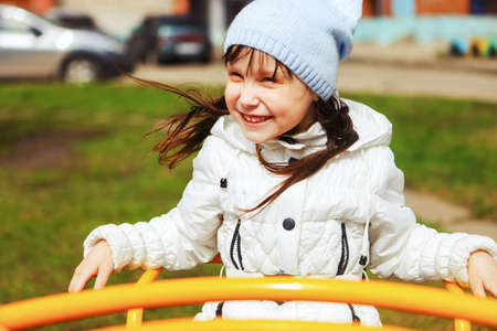 The little girl happy outdoors in playground.の写真素材