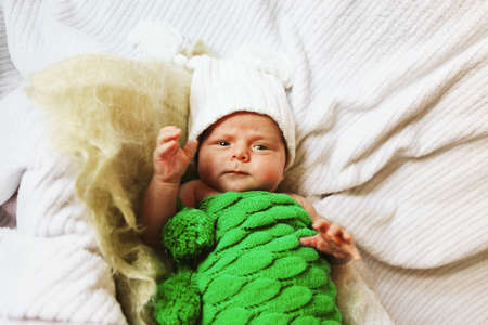 A little baby lies in the crib.の写真素材