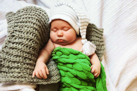 A little baby lies in the crib.の写真素材