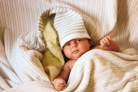 A little baby lies in the crib.の写真素材