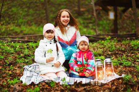 The children happy outdoors sitting on park.の写真素材