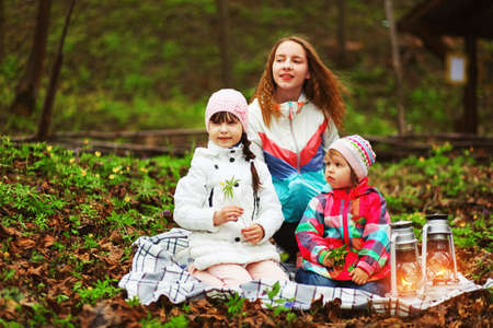 The children happy outdoors sitting on park.の写真素材