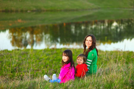 The Family happy outdoor rest a river.の写真素材