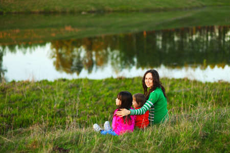 The Family happy outdoor rest a river.の写真素材