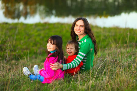 The Family happy outdoor rest a river.の写真素材
