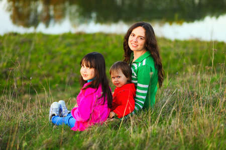 The Family happy outdoor rest a river.の写真素材