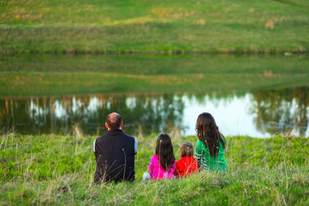 The Family happy outdoor rest a river.の写真素材