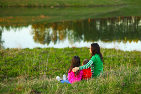 The Family happy outdoor rest a river.の写真素材