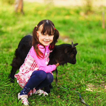 The Children happy outdoors feeding a goats.の写真素材