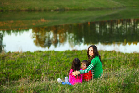 The Family happy outdoor rest a river.の写真素材