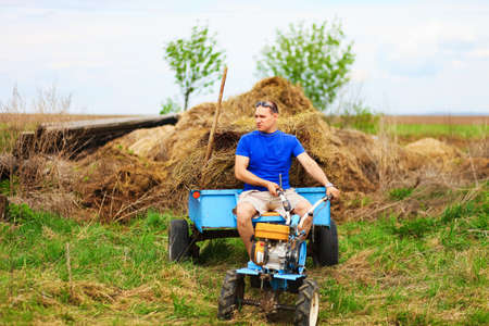 The man carries hay on a cart.の写真素材