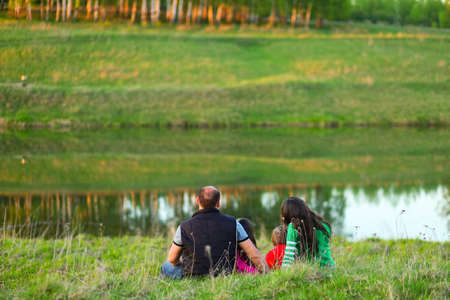 The Family happy outdoor rest a river.の写真素材