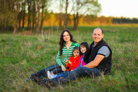The Family happy outdoor rest a river.の写真素材