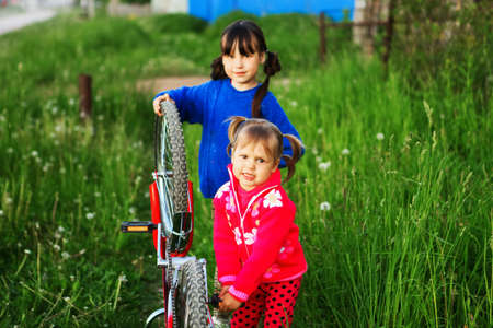 Little girls Bicycle repair on the outdoors.の写真素材