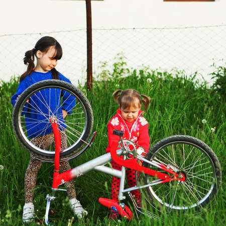 Little girls Bicycle repair on the outdoors.の写真素材