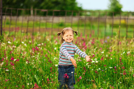 Cute portrait of a girl in the field.の写真素材
