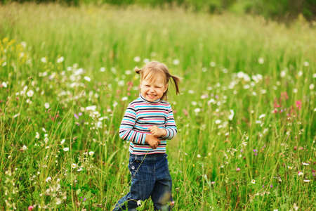 Cute portrait of a girl in the field.の写真素材