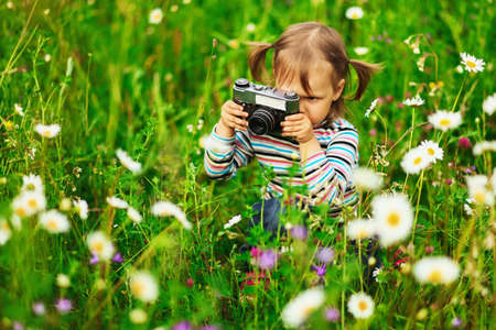 Child pictures of flowers on the meadow.の写真素材