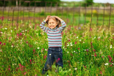 Cute portrait of a girl in the field.の写真素材
