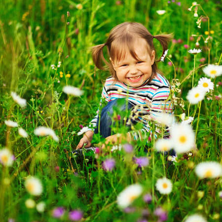 Cute portrait of a girl in the field.の写真素材