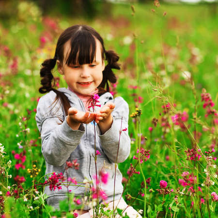 Cute portrait of a girl in the field.の写真素材