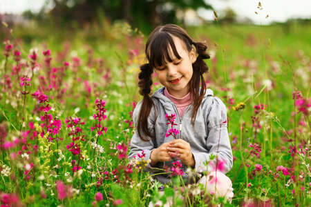 Cute portrait of a girl in the field.の写真素材