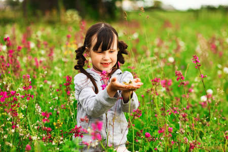 Cute portrait of a girl in the field.の写真素材