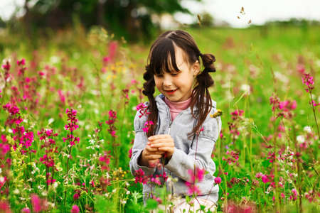 Cute portrait of a girl in the field.の写真素材