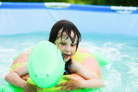 Children swim in the pool in garden.の写真素材