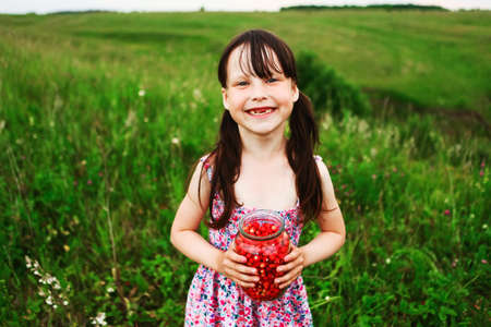 The Little girl picking and eating strawberries.の写真素材