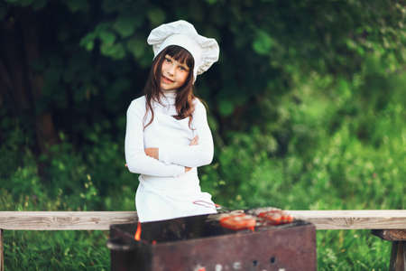 The Children preparing sausages on the coals.の写真素材