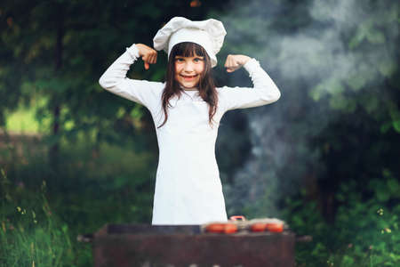The Children preparing sausages on the coals.の写真素材