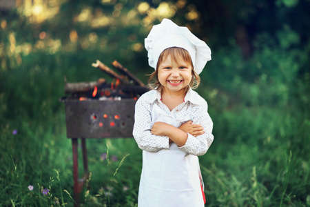 The Children preparing sausages on the coals.の写真素材