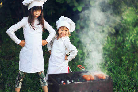 The Children preparing sausages on the coals.の写真素材