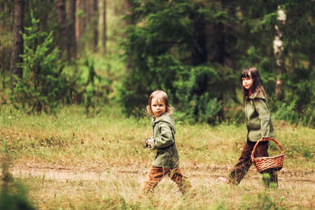 The Small children walk in the forest.の写真素材