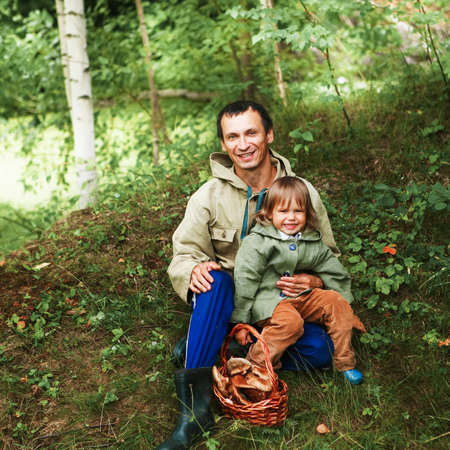 The children gather mushrooms in the forest.の写真素材