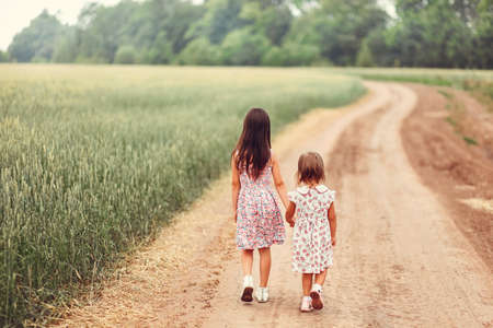 Children play in a field of golden rye.の写真素材