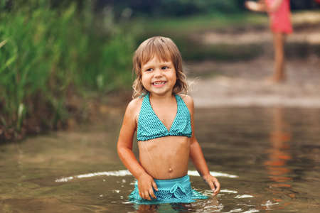 The Little girl swimming in the lake.の写真素材