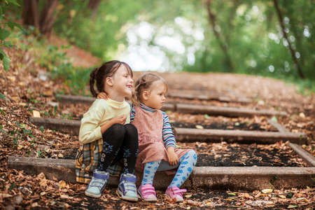 The Small children sitting on the stairs.の写真素材