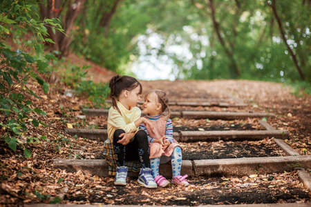 The Small children sitting on the stairs.の写真素材
