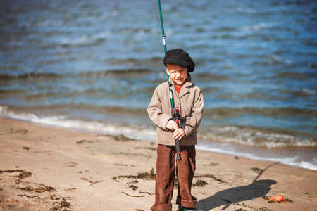 The Small children fishing on the river.の写真素材