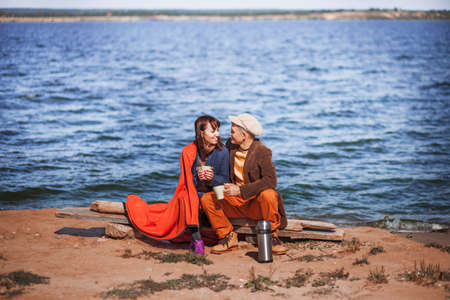 The Young couple resting on the river.の写真素材