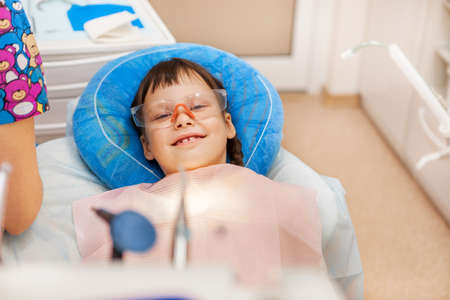 Little girl treats teeth at the dentist.の写真素材