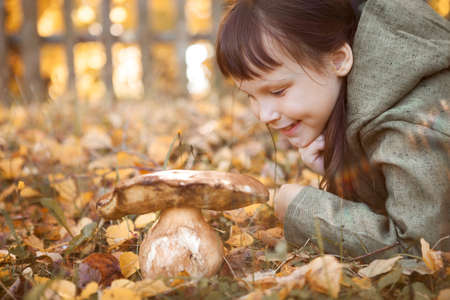 The little girl went to pick mushrooms.の写真素材