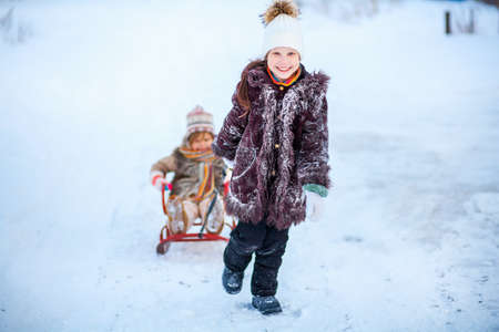 The Little child playing a winter outdoors.の写真素材