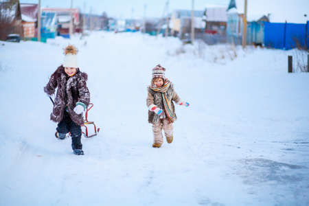 The Little child playing a winter outdoors.の写真素材